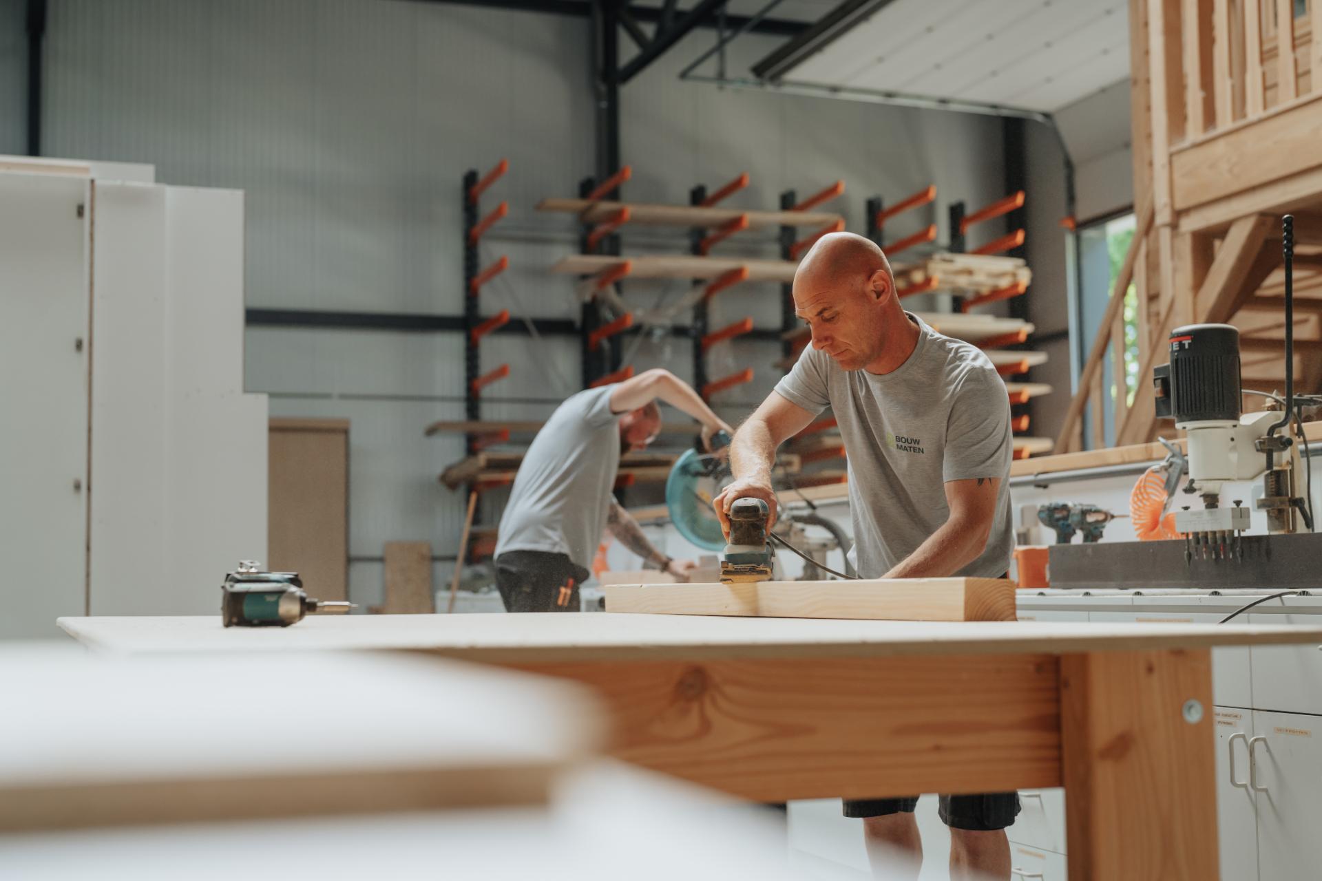 Schrijnwerker van Bouw Maten werkt aan maatwerk houtbewerking in de werkplaats